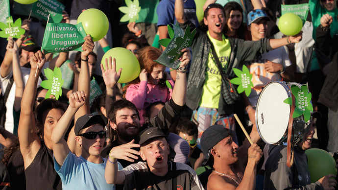 People participate in the so-called "Last demonstration with illegal marijuana" on their way to the Congress building in Montevideo, as Senate debates a government-sponsored bill establishing state regulation of the cultivation, distribution and consumption of marijuana during a session, December 10, 2013. (Reuters / Andres Stapff) 