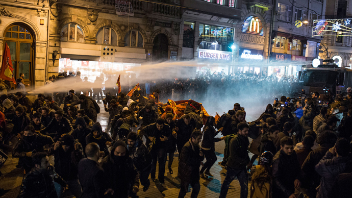 Police use a water cannon to try to disperse people protesting against newly proposed restrictions on the use of the internet and against the Turkish government during a protest on the Istiklal Avenue in Istanbul, on January 18, 2014 (AFP Photo / Mete Carkci)