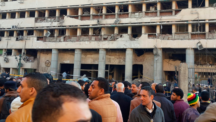 Police officers and people gather in front of the destroyed Islamic Museum building, after a bomb blast occurred at the police headquarters nearby, in downtown Cairo, January 24, 2014. (Reuters / Amr Abdallah Dalsh) 