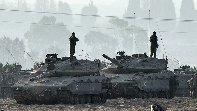 Israeli soldiers stand on Merkava tanks in an army deployment area near Israel's border with the Gaza Strip on July 8, 2014 (AFP Photo / Jack Guez)