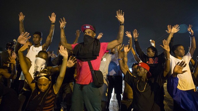 Demonstrators confront police with their arms raised during on-going demonstrations to protest against the shooting of Michael Brown, in Ferguson, Missouri, August 16, 2014. (Reuters/Lucas Jackson)