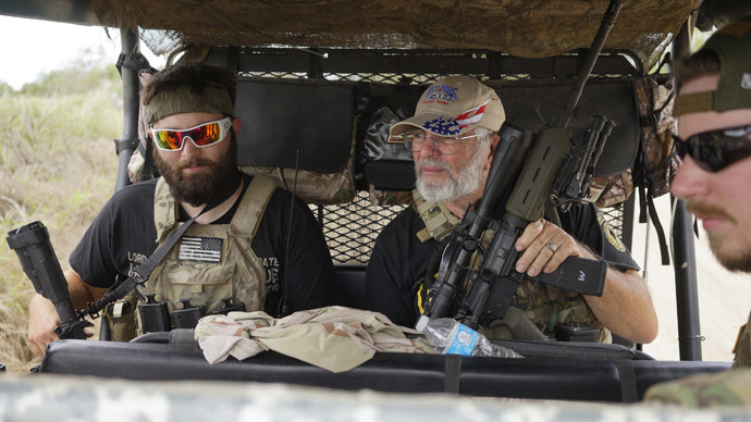 Members of the "Patriots" Huggie Bear (L, not his real name), Ray (C, no last name given) and Will (R, no last name given) patrol in their UTV near a camp of patriots near the U.S.-Mexico border outside Brownsville, Texas September 2, 2014. (Reuters/Rick Wilking)