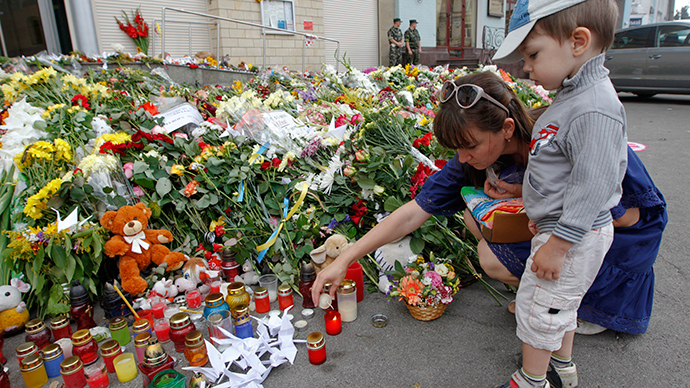 Local residents light a candle for victims of Malaysia Airlines Flight MH17, outside the Dutch embassy in Kiev  (Reuters)