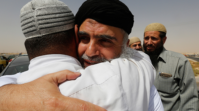Radical Muslim cleric Abu Qatada (C) hugs his family members after his release from a prison near Amman September 24, 2014 (Reuters / Muhammad Hamed)