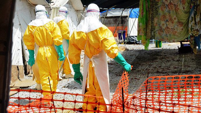 Guinea health workers wearing protective suits join members of the Medecins sans frontieres Ebola treatement centre near the main Donka hospital in Conakry on September 25, 2014.(AFP Photo / Cellou Binani)