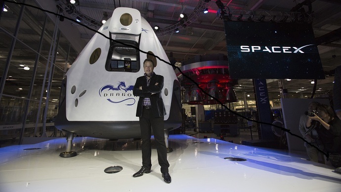 SpaceX CEO Elon Musk poses by the Dragon V2 spacecraft (Reuters/Mario Anzuoni)