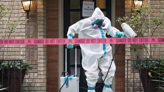 A member of the CG Environmental HazMat team disinfects the entrance to the residence of a health worker at the Texas Health Presbyterian Hospital who has contracted Ebola in Dallas, Texas, October 12, 2014. (Reuters/Jaime R. Carrero)