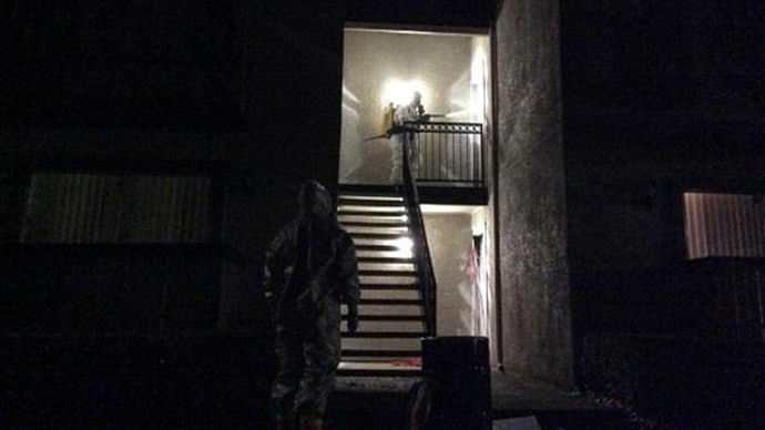 Emergency personnel wearing protective clothing approach a residential apartment after a second healthcare worker tested positive for the Ebola virus in Dallas, in a photo provided by the Dallas Police Department October 15, 2014.(Reuters / Dallas Police Department)