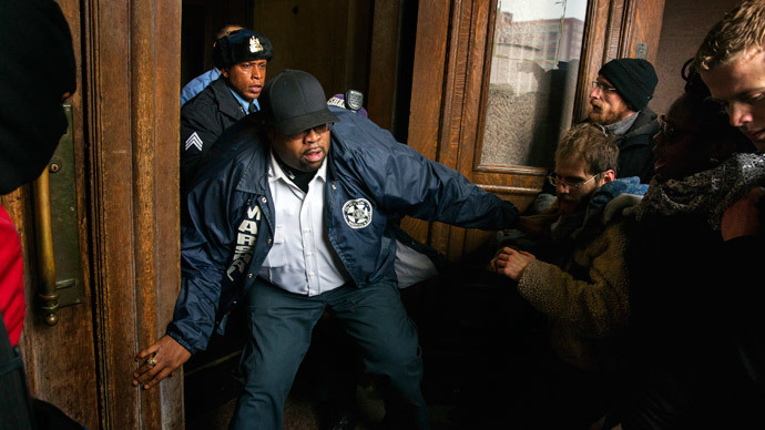 A City Marshal tries to stop a group of protesters from entering St. Louis City Hall in St. Louis, Missouri November 26, 2014. (Reuters / Lucas Jackson)