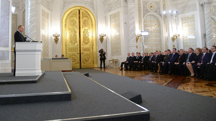 Russian President Vladimir Putin, left, delivers the annual Presidential Address to the Federal Assembly in the Kremlin's St. George's Hall. (RIA Novosti/Alexander Astafyev)