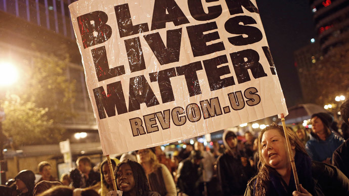 ﻿﻿Protesters hold a sign during a march against the New York City grand jury decision to not indict in the death of Eric Garner, in Oakland, California December 3, 2014.(Reuters / Stephen Lam)