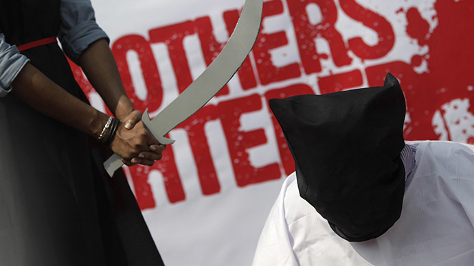 FILE PHOTO: Members of Magic Movement stage a mock execution scene in protest of Saudi Arabia beheading of eight Bangladeshi workers in October 2011. (Reuters/Andrew Biraj)