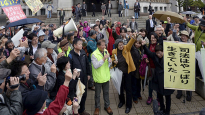 Local residents and their supporters celebrate after the Fukui District Court issued an injunction to prevent the restart of two nuclear reactors at Takahama nuclear power plant, in front of the court in Fukui, northwestern Japan, in this photo taken by Kyodo April 14, 2015.(Reuters / Kyodo)