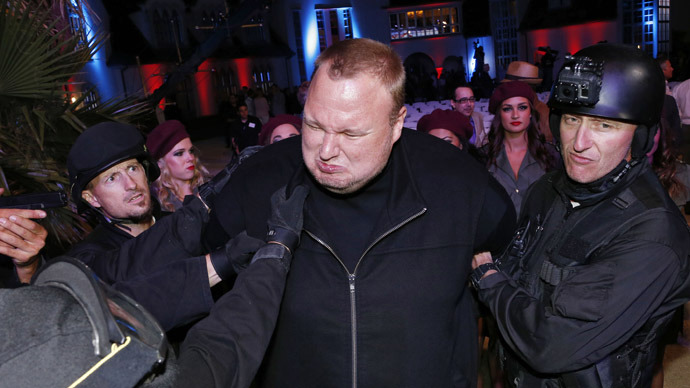 Actors in police costume mock-arrest Megaupload founder Kim Dotcom (C), as he launches his new file sharing site "Mega" in Auckland January 20, 2013. (Reuters/Nigel Marple)