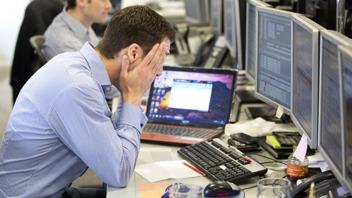 A trader reacts on the IG Group trading floor in London March 18, 2013. (Reuters/Neil Hall)