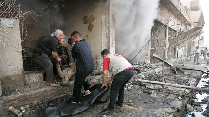 Men carry a dead body after a car bomb attack in Kirkuk, 250 km (155 miles) north of Baghdad, June 20, 2012. (Reuters/Ako Rasheed)
