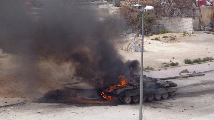 A tank belonging to forces loyal to Syria's President Bashar al-Assad is set on fire during what activists said were clashes between government forces and the Free Syrian Army, in the main south highway near Damascus, March 19, 2013 (Reuters / Mohammed Dimashkia)