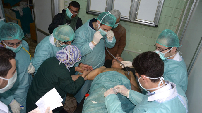 : In this image made available by the Syrian News Agency (SANA) on March 19, 2013, medics and other masked people attend to a man at a hospital in Khan al-Assal in the northern Aleppo province, as Syria's government accused rebel forces of using chemical weapons for the first time (AFP Photo / SANA)