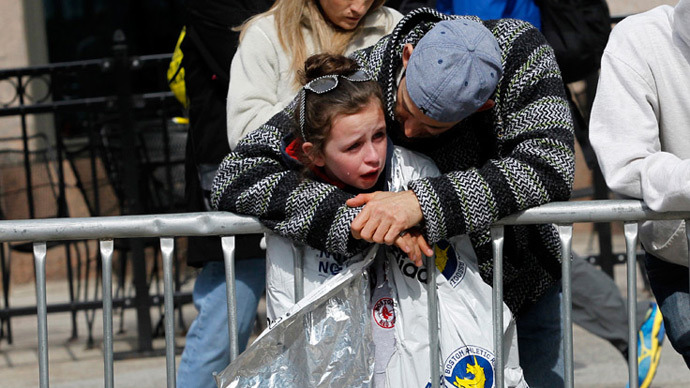 A child is comforted after explosions went off at the 117th Boston Marathon in Boston, Massachusetts April 15, 2013 (Reuters / Jessica Rinaldi)