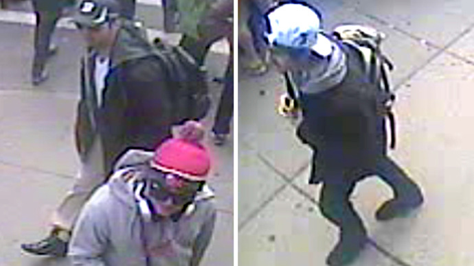 These images taken from a video released by the FBI on April 18, 2013 shows Suspect One (L) and Suspect Two (R) walking along the route of the Boston Marathon on April 15, 2013 (AFP Photo / FBI)