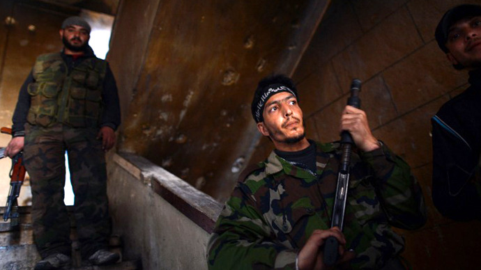 Syrian rebels take position inside a building in the Saif al-Dawla district of the northern Syrian city of Aleppo on April 5, 2013. (AFP Photo / Dimitar Dilkoff)