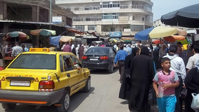 A handout picture released by the Syrian Arab News Agency (SANA) on May 21, 2013, shows people gathering in a market in in the northwestern province of Idlib. (AFP/SANA)