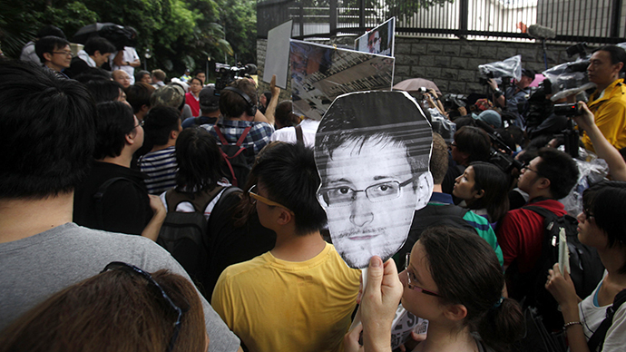 A protester carries a paper cutout of Snowden (Reuters / Bobby Yip)