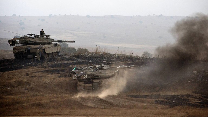 Israeli Merkava tanks roll during a military exercise in the Israeli-annexed Golan Heights near the border with Syria on July 18, 2013. (AFP Photo / Jack Guez)
