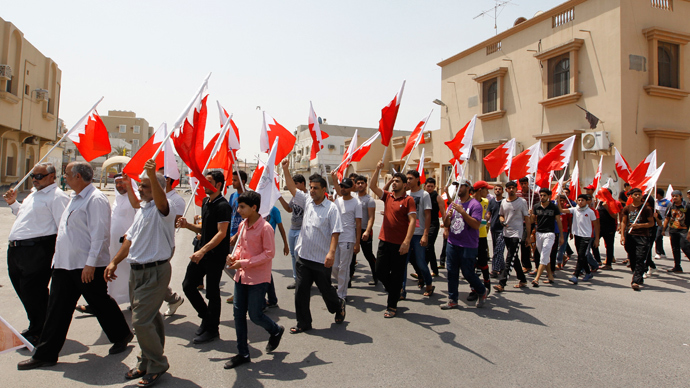 Anti-government protesters holding Bahraini flags march along the streets of the village of Saar during an anti-government protest, west of Manama, August 14, 2013 (Reuters / Hamad I Mohammed)