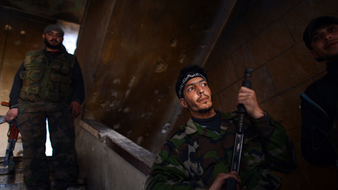 Syrian rebels take position inside a building in the Saif al-Dawla district of the northern Syrian city of Aleppo on April 5, 2013. (AFP Photo / Dimitar Dilkoff)