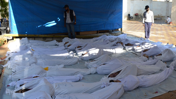 Syrian activists inspect the bodies of people they say were killed by nerve gas in the Ghouta region, in the Duma neighbourhood of Damascus August 21, 2013. (Reuters)