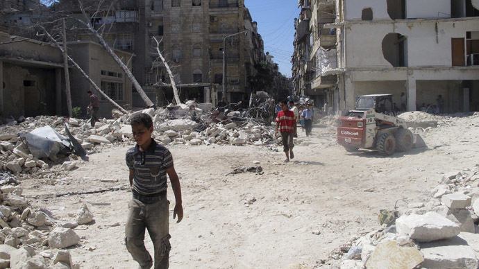 Men walk on rubble of buildings damaged by what activists said was shelling by forces loyal to Syria's President Bashar al-Assad in Aleppo's Bustan al-Qasr district, September 9, 2013. Picture taken September 9, 2013. (Reuters/Abdalghne Karoof)