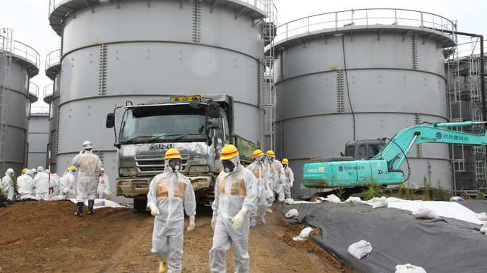 This handout picture taken by Japan's Nuclear Regulation Authority on August 23, 2013 shows nuclear watchdog members including Nuclear Regulation Authority members in radiation protection suits inspecting contaminated water tanks at the Tokyo Electric Power Co (TEPCO) Fukushima Dai-ichi nuclear power plant in the town of Okuma, Fukushima prefecture. (AFP Photo)