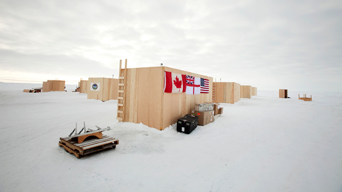 Plywood buildings used to house participants have the flags of Canada, the British Royal Navy, and the United states draped on their side at the Applied Physics Lab Ice Station in the Arctic north of Prudhoe Bay, Alaska (Reuters / Lucas Jackson)