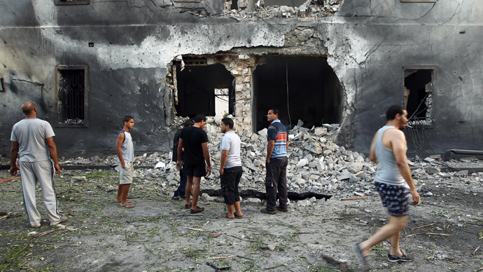 Libyans gather outside a foreign ministry building that was hit by a powerful blast on September 11, 2013 in the eastern Libyan city of Benghazi (AFP Photo / Abdullah Doma)