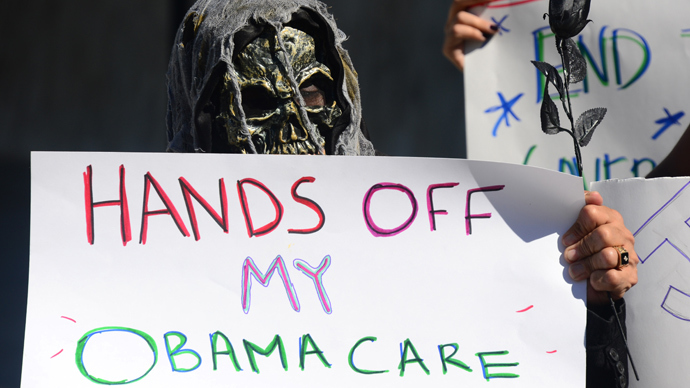 Activists with the California Alliance for Retired Americans hold placards while gathered for a die-in to protest the government shutdown and possible effects on senior citizens in front of the Federal Building in Los Angeles on October 16, 2013 (AFP Photo / Frederic J. Brown)