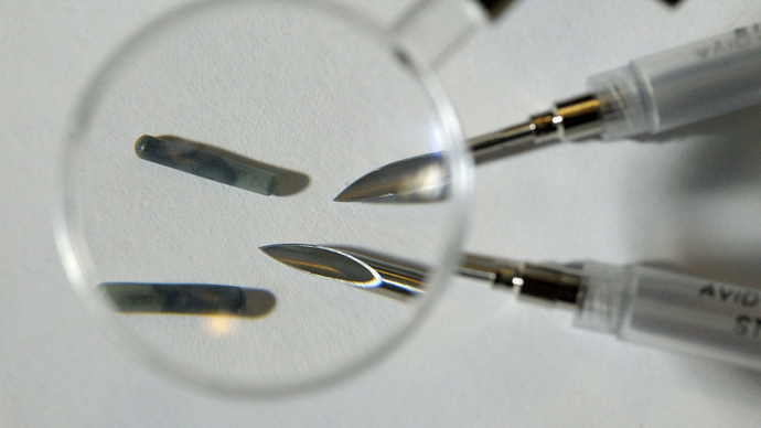 Tiny radio frequency identification (RFID) computer chips with the needles used to implant them under the skin (Reuters)