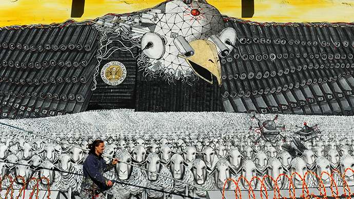 The group's mural titled "Surveillance of the fittest" featuring the emblematic US eagle with a badge that reads "National Security Agency worldwide" in Cologne, Germany on October 24, 2013. (AFP Photo / Marius Becker)