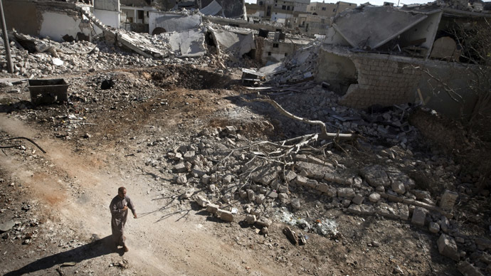 A man walks through a destroyed residential area of the Syrian city of Saraqib, southwest of Aleppo, on September 9, 2013 (AFP Photo)