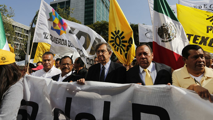Cuauhtemoc Cardenas (C), founder of the Party of the Democratic Revolution (PRD), and party's president Jesus Zambrano (2nd R) march against the energy reform bill at the Angel of Independence in Mexico City December 10, 2013. (Reuters/Tomas Bravo)