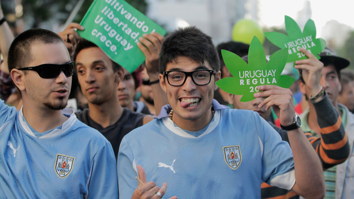 People participate in the so-called "Last demonstration with illegal marijuana" on their way to the Congress building in Montevideo, as Senate debates a government-sponsored bill establishing state regulation of the cultivation, distribution and consumption of marijuana during a session (Reuters / Andres Stapff)
