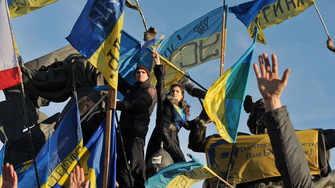Ukrainian opposition supporters raise their hands as they take part in a mass rally on Independence Square in Kiev, on December 22, 2013.(AFP Photo / Genya Savilov)