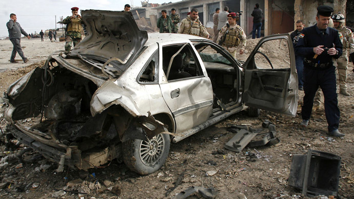 Iraqi security forces inspect the site of a blast in Bartala in the Nineveh province, north of Baghdad, on January 16, 2012. (AFP photo)