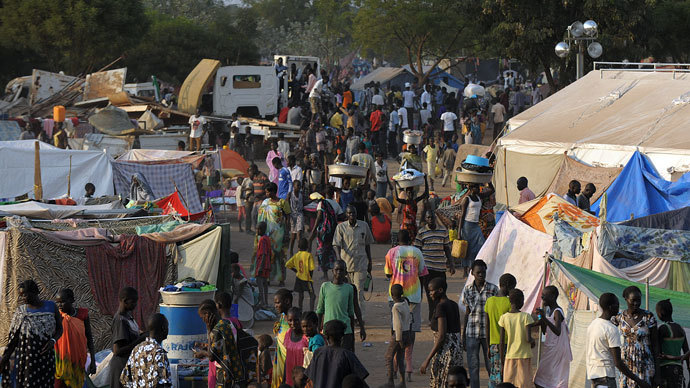 People gather at a makeshift IDP camp at the United Nations Mission in South Sudan (UNMISS) compound in Juba on December 22, 2013 where South Sudanese continue to flock as fears of a resumption of fighting in the capital fester.(AFP Photo / Tony Karumba)