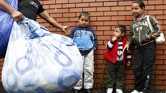 Romanian children are moved along by their father as he arrives with some of their possessions at the Ozone Leisure Centre in East Belfast (Reuters / Cathal McNaughton)