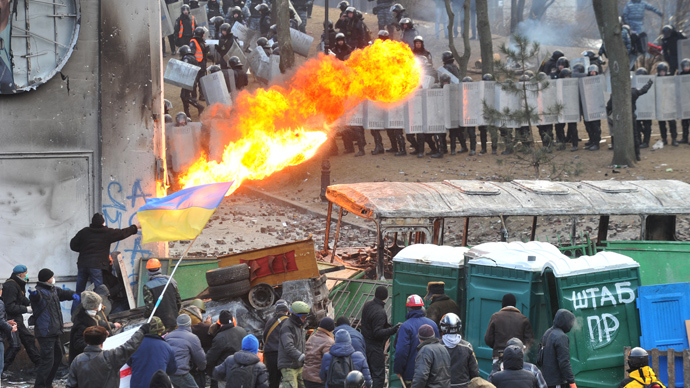 A protester sprays fire in the direction of the riot police during clashes in the centre of Kiev on January 20, 2014 (AFP Photo / Genya Savilov)