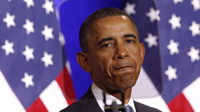 U.S. President Barack Obama is seen through a teleprompter as he speaks about the National Security Agency from the Justice Department in Washington January 17, 2014. (Reuters/Kevin Lamarque)