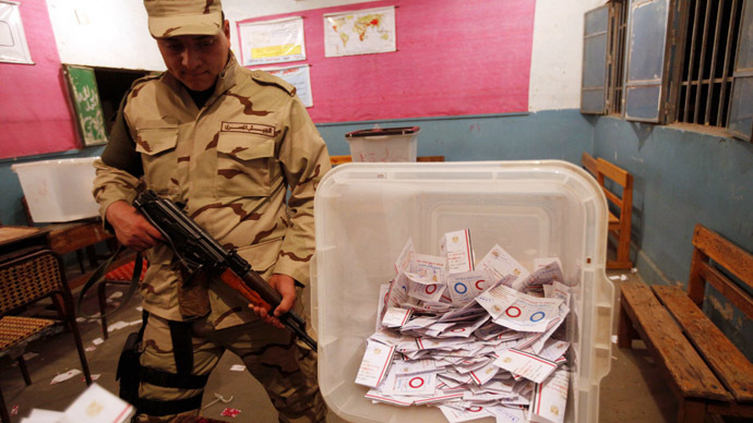An Egyptian army soldier stands guard as officials count ballots after polls closed during the final stage of a referendum on Egypt's new constitution at the constitutional referendum commission in Cairo, January 15, 2014. (Reuters)