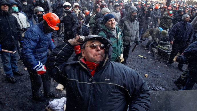 A pro-European integration protester throws stones towards riot police in Kiev January 23, 2014.(Reuters / Vasily Fedosenko)