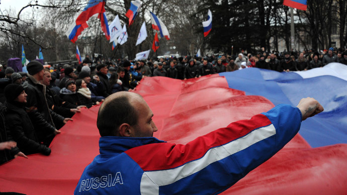 Pro-Russian demonstrators carry a giant Russian flag as they rally in central Simferopol on February 27, 2014. (AFP Photo / Viktor Drachev)